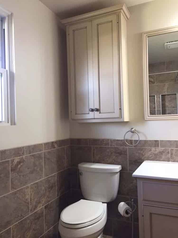 white cabinet above toilet