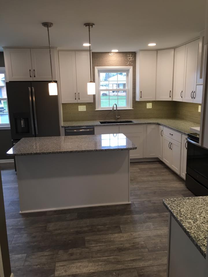 white kitchen with granite counter tops