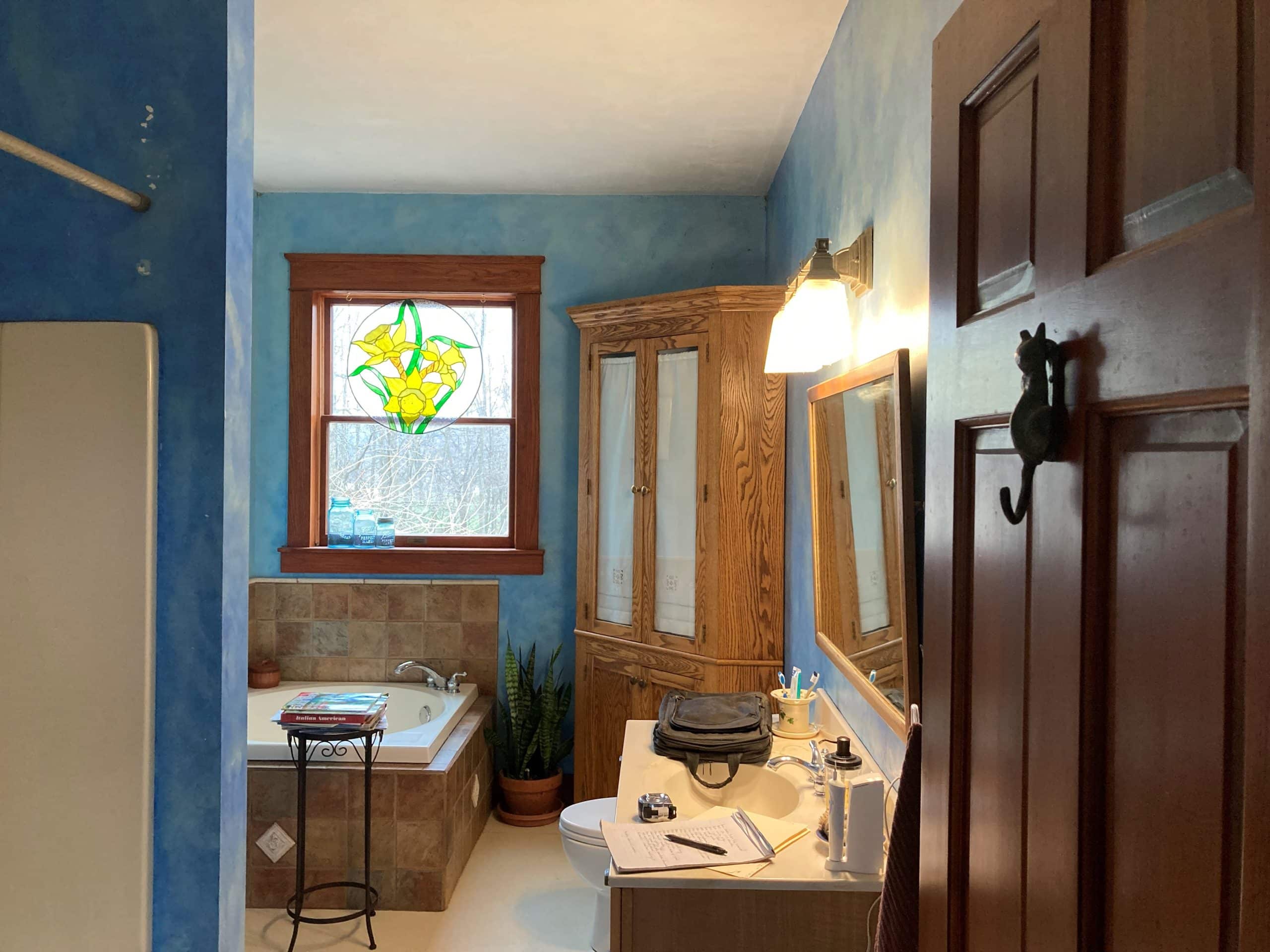 blue bathroom with wooden dresser